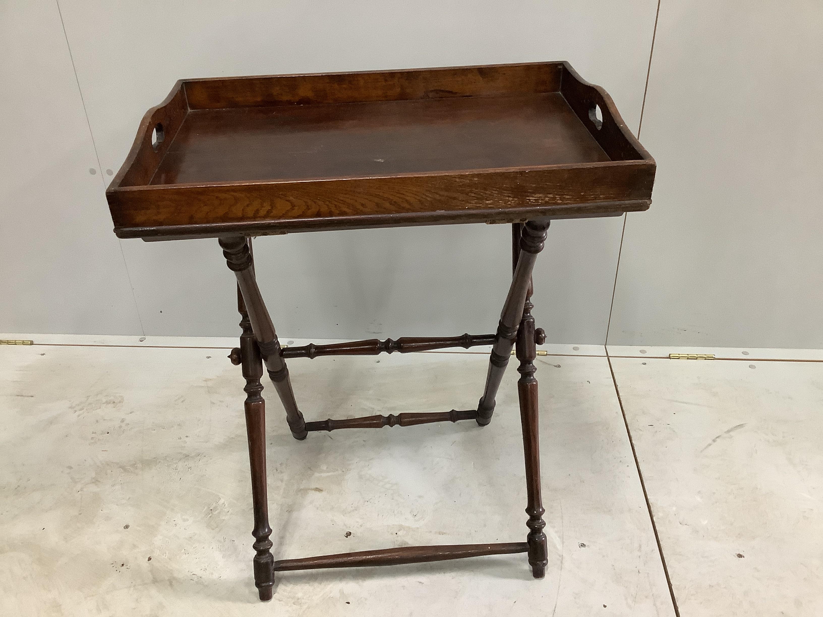 A late Victorian rectangular oak butler's tray on folding stand, width 65cm, depth 44cm, height 81cm